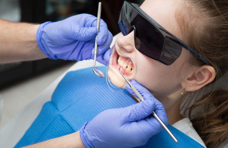 Smiling young girl in a dental chair during a pediatric visit